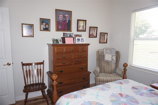 bedroom with baseboards and multiple windows