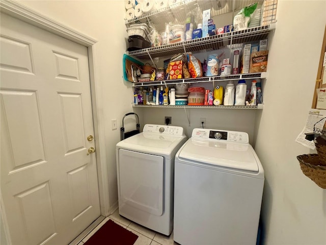laundry area featuring separate washer and dryer, laundry area, and tile patterned floors