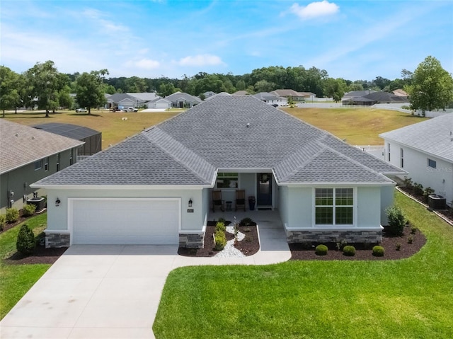 ranch-style home featuring an attached garage, a shingled roof, stone siding, and cooling unit