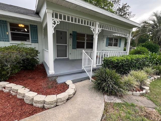 entrance to property featuring a porch and board and batten siding