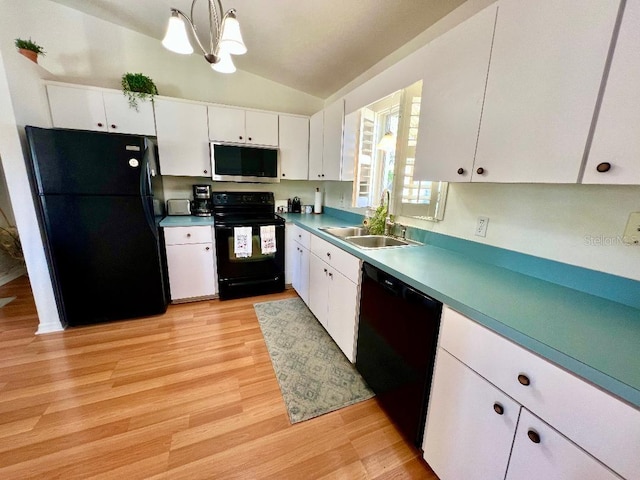 kitchen featuring black appliances, lofted ceiling, a sink, white cabinets, and light wood-style flooring