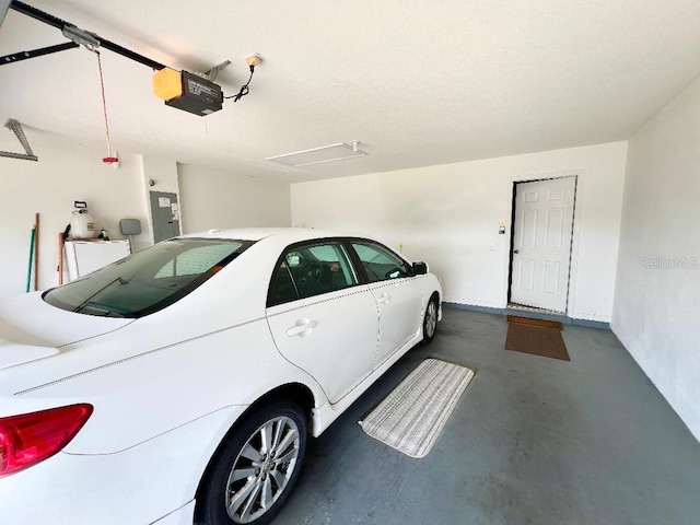 garage with a garage door opener and electric panel