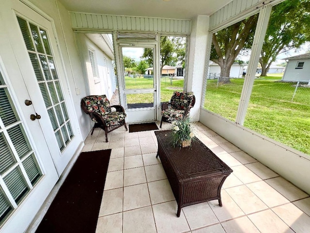 sunroom / solarium featuring healthy amount of natural light