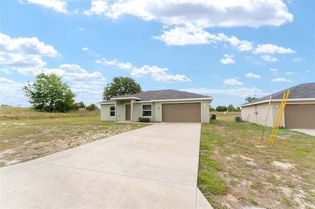 69 Juniper Trail Loop, Ocala, FL 34480 - prairie-style home with concrete driveway, an attached garage, and a front yard