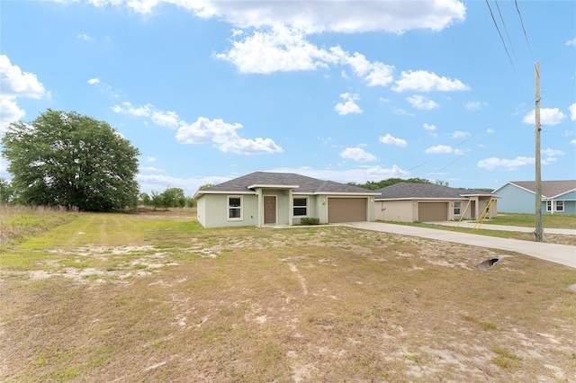 69 Juniper Trail Loop, Ocala, FL 34480 - view of front facade with an attached garage, a front lawn, and driveway