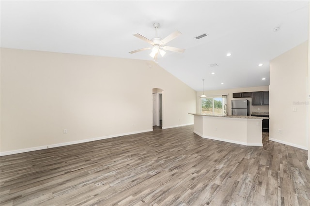 69 Juniper Trail Loop, Ocala, FL 34480 - unfurnished living room with a sink, wood finished floors, visible vents, arched walkways, and a ceiling fan
