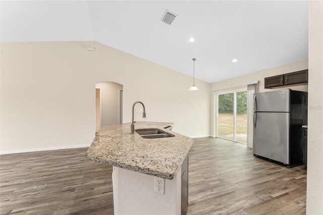 69 Juniper Trail Loop, Ocala, FL 34480 - kitchen with freestanding refrigerator, lofted ceiling, visible vents, a sink, and arched walkways