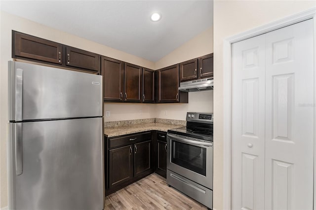 69 Juniper Trail Loop, Ocala, FL 34480 - kitchen featuring under cabinet range hood, dark brown cabinetry, vaulted ceiling, stainless steel appliances, and light wood-type flooring