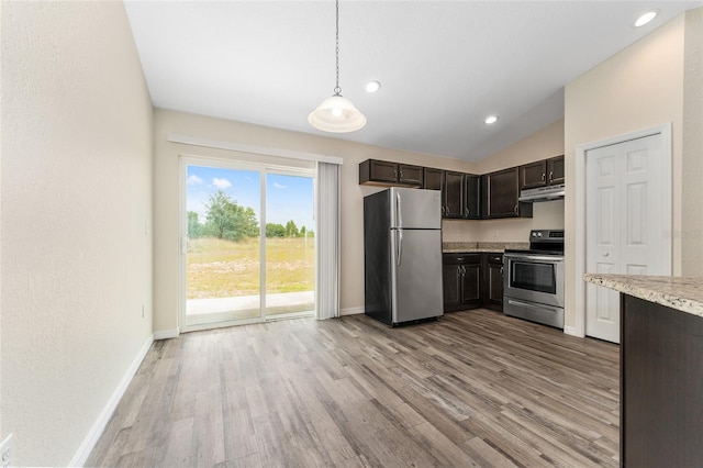 69 Juniper Trail Loop, Ocala, FL 34480 - kitchen with under cabinet range hood, baseboards, light wood-type flooring, and appliances with stainless steel finishes