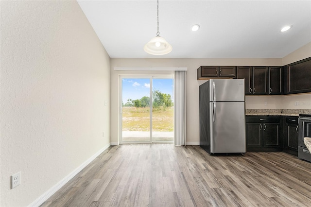 69 Juniper Trail Loop, Ocala, FL 34480 - kitchen featuring freestanding refrigerator, light wood-style flooring, and baseboards