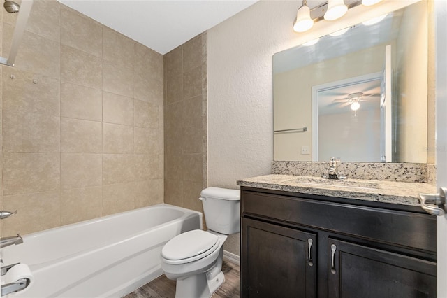 69 Juniper Trail Loop, Ocala, FL 34480 - full bathroom featuring toilet,  shower combination, ceiling fan, vanity, and wood finished floors