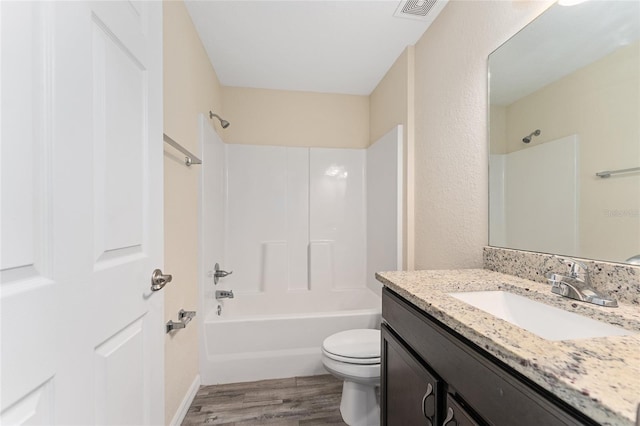 69 Juniper Trail Loop, Ocala, FL 34480 - full bathroom with toilet, visible vents, vanity, wood finished floors, and washtub / shower combination