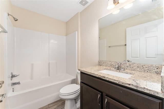 69 Juniper Trail Loop, Ocala, FL 34480 - bathroom featuring toilet, wood finished floors, vanity, visible vents, and tub / shower combination