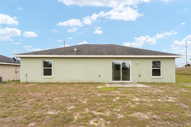 69 Juniper Trail Loop, Ocala, FL 34480 - rear view of house with cooling unit, a patio, stucco siding, and a lawn