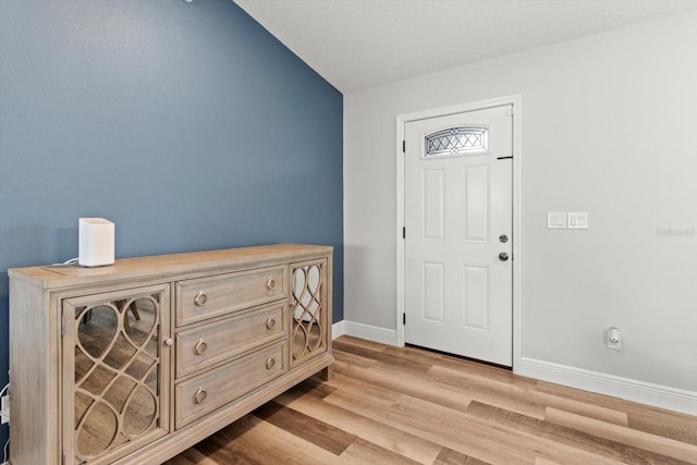 9 Walnut Run, Ocala, FL 34480 - entrance foyer featuring baseboards, light wood-style flooring, and vaulted ceiling