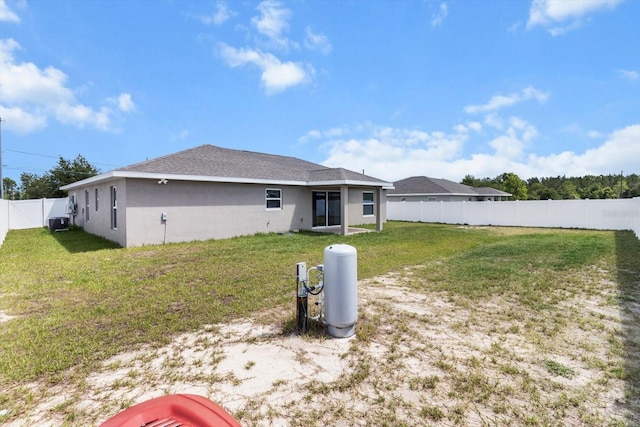 9 Walnut Run, Ocala, FL 34480 - rear view of property with a lawn, central AC unit, stucco siding, and a fenced backyard