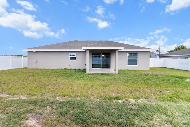 9 Walnut Run, Ocala, FL 34480 - back of house with a lawn, stucco siding, and a fenced backyard