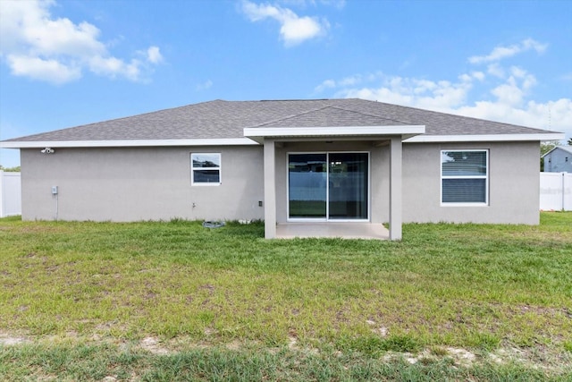 9 Walnut Run, Ocala, FL 34480 - back of property featuring a shingled roof, a yard, stucco siding, and fence