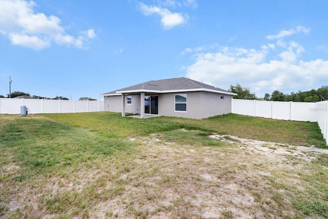 9 Walnut Run, Ocala, FL 34480 - back of house with a lawn, stucco siding, and a fenced backyard