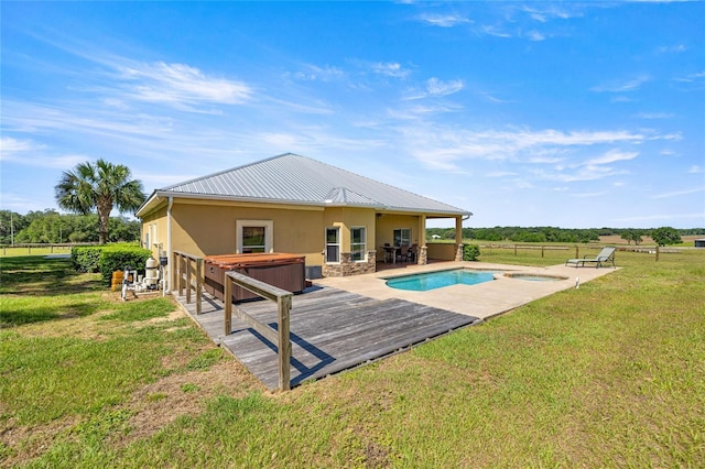outdoor pool with an outdoor hot tub, a lawn, fence, and a patio