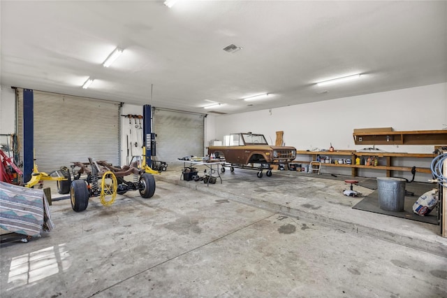 garage with visible vents and a workshop area