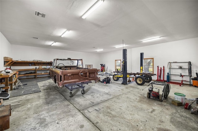 garage with visible vents and a workshop area