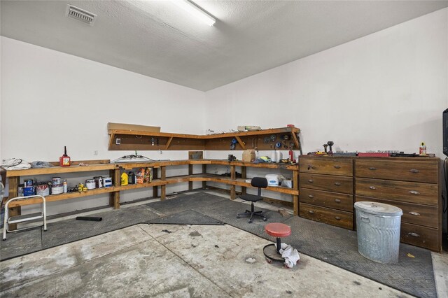 misc room featuring a workshop area and visible vents