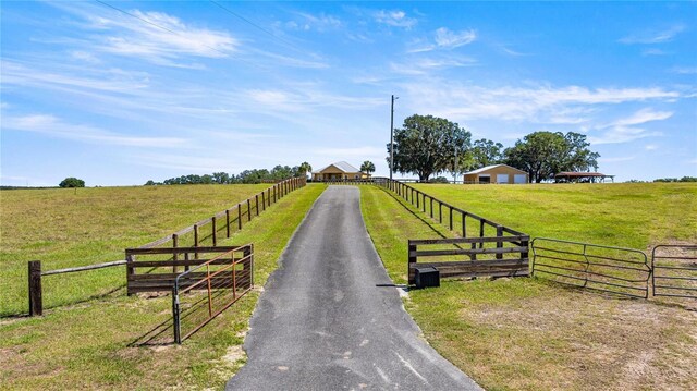 view of road featuring driveway and a rural view