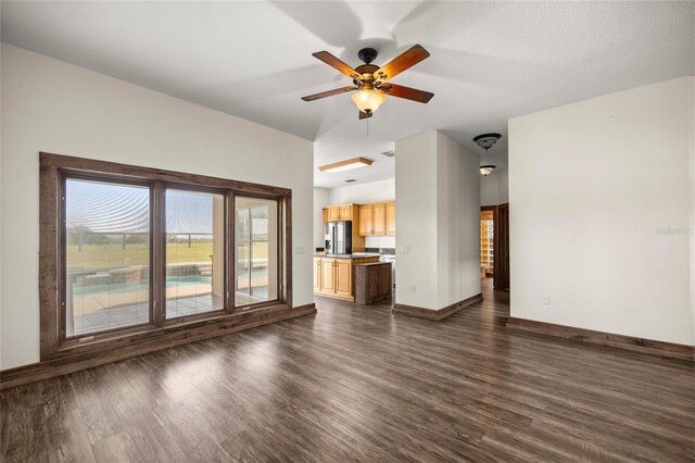 unfurnished living room with baseboards, a ceiling fan, and dark wood-style flooring