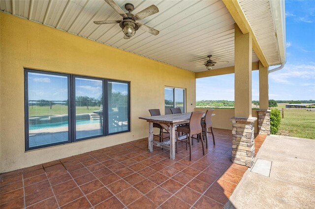 view of patio featuring a ceiling fan and outdoor dining space