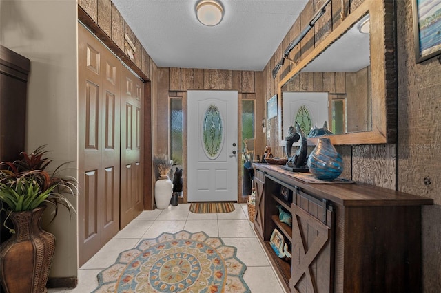 4710 SE 30th Ct, Ocala, FL 34480 - entryway with light tile patterned floors, wood walls, and a textured ceiling