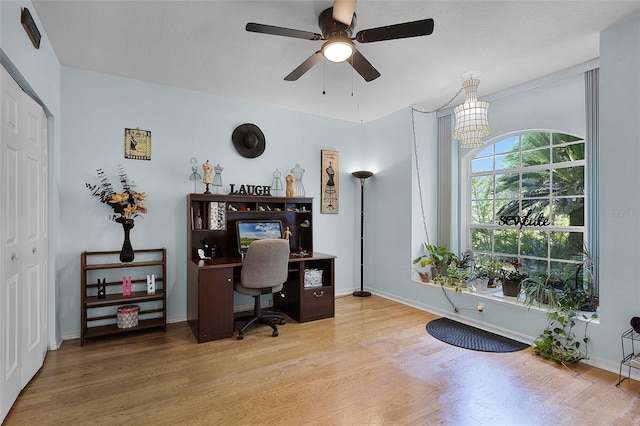 office area with wood finished floors, a ceiling fan, a chandelier, and baseboards