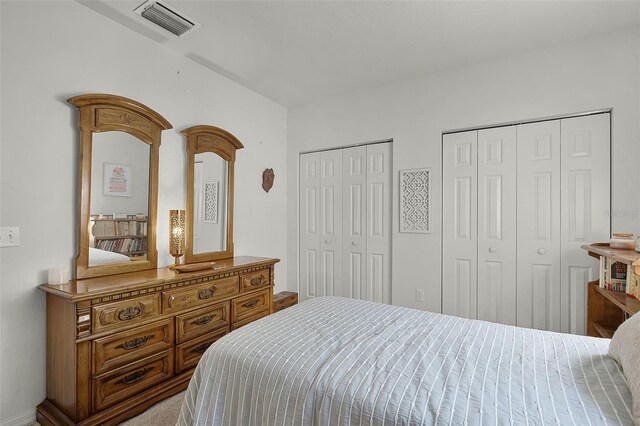 bedroom with two closets