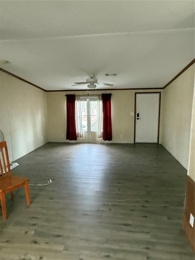 unfurnished living room featuring ornamental molding, a ceiling fan, wood finished floors, and visible vents