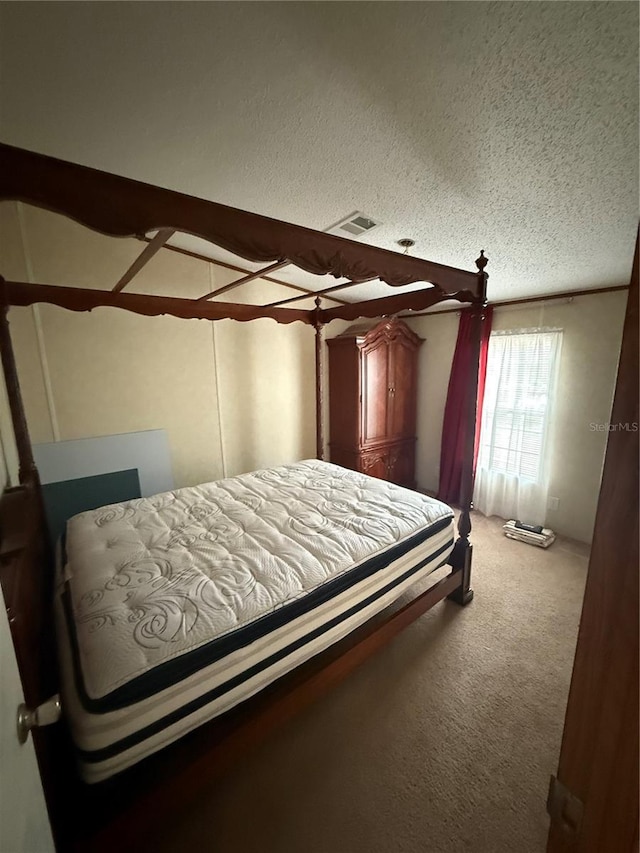 carpeted bedroom featuring visible vents