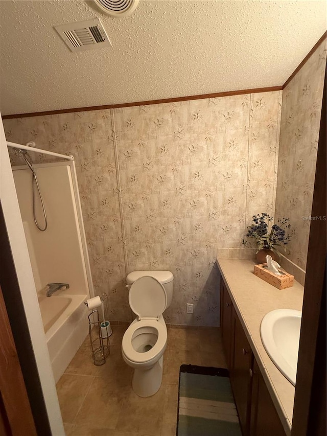 bathroom with a textured ceiling, visible vents, vanity, toilet, and wallpapered walls