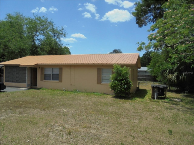 2912 NE 24th Ct, Ocala, FL 34479 - exterior space featuring stucco siding, a yard, and metal roof