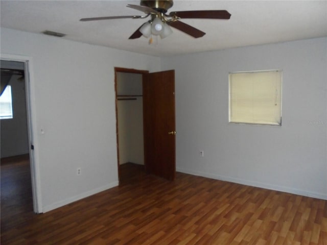 2912 NE 24th Ct, Ocala, FL 34479 - unfurnished bedroom with baseboards, a ceiling fan, wood finished floors, and visible vents