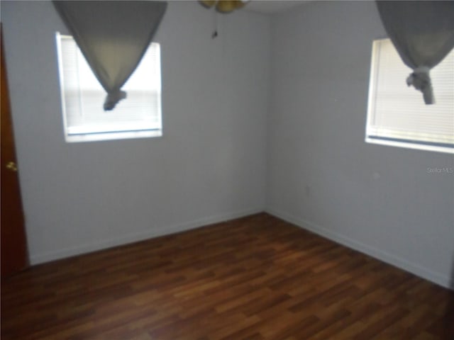 2912 NE 24th Ct, Ocala, FL 34479 - spare room featuring dark wood-type flooring, a ceiling fan, and baseboards