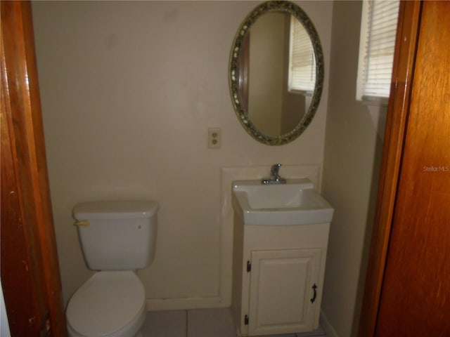 2912 NE 24th Ct, Ocala, FL 34479 - bathroom with toilet, baseboards, tile patterned flooring, and vanity