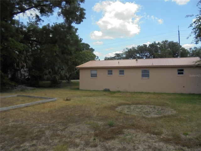 2912 NE 24th Ct, Ocala, FL 34479 - view of home's exterior featuring a yard and metal roof