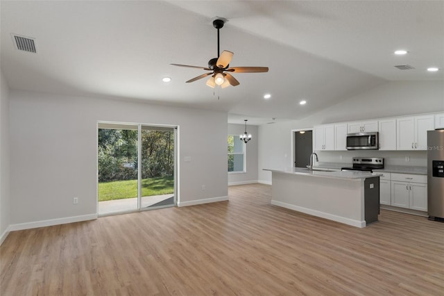 kitchen with open floor plan, appliances with stainless steel finishes, light wood finished floors, and visible vents