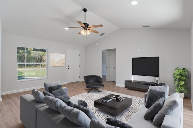 living area featuring light wood-type flooring, a ceiling fan, lofted ceiling, and visible vents