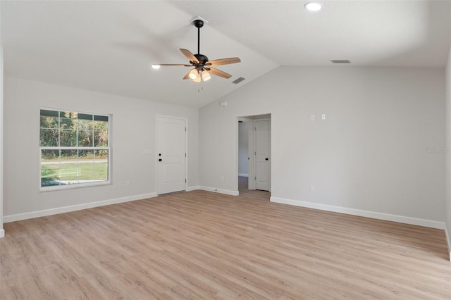 spare room with visible vents, ceiling fan, light wood-style flooring, and lofted ceiling