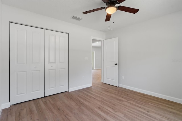 unfurnished bedroom featuring baseboards, light wood-style flooring, and visible vents