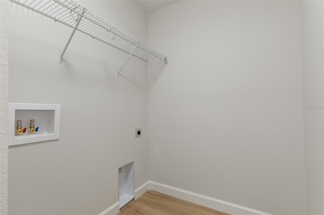 laundry room with laundry area, light wood-style floors, baseboards, hookup for a washing machine, and hookup for an electric dryer
