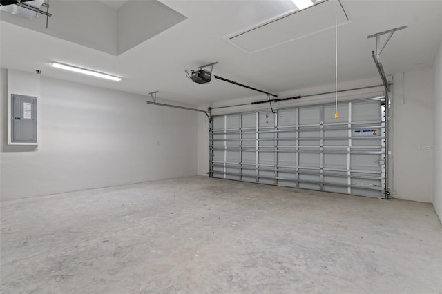 garage with a garage door opener and electric panel