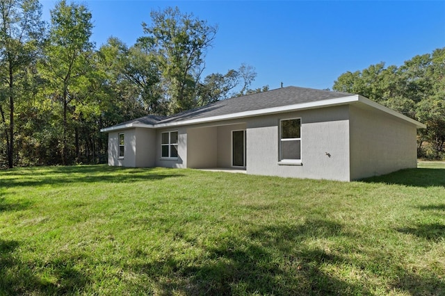 back of house featuring a yard