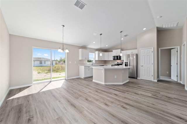 kitchen featuring stainless steel appliances, a center island, light countertops, a chandelier, and white cabinets