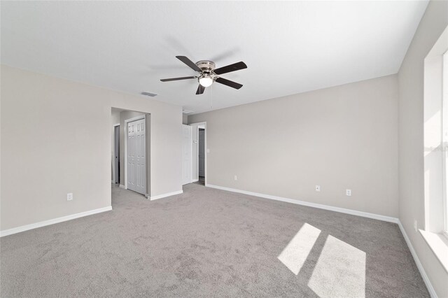 unfurnished bedroom featuring carpet flooring, baseboards, and ceiling fan